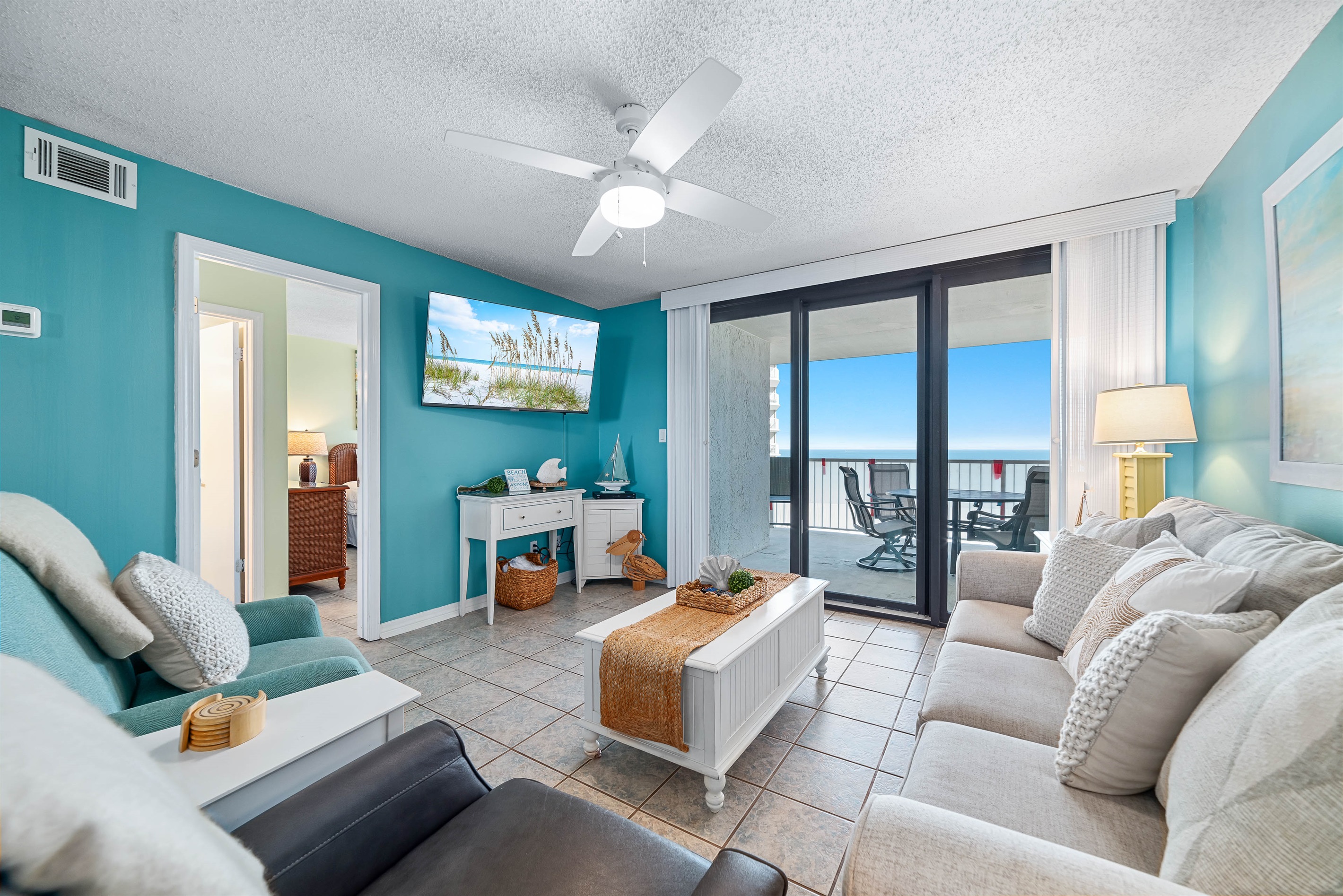 Experience coastal comfort in this beautifully appointed living room. Featuring a plush sleeper sofa for extra guests and direct access to your private balcony overlooking the serene waters.