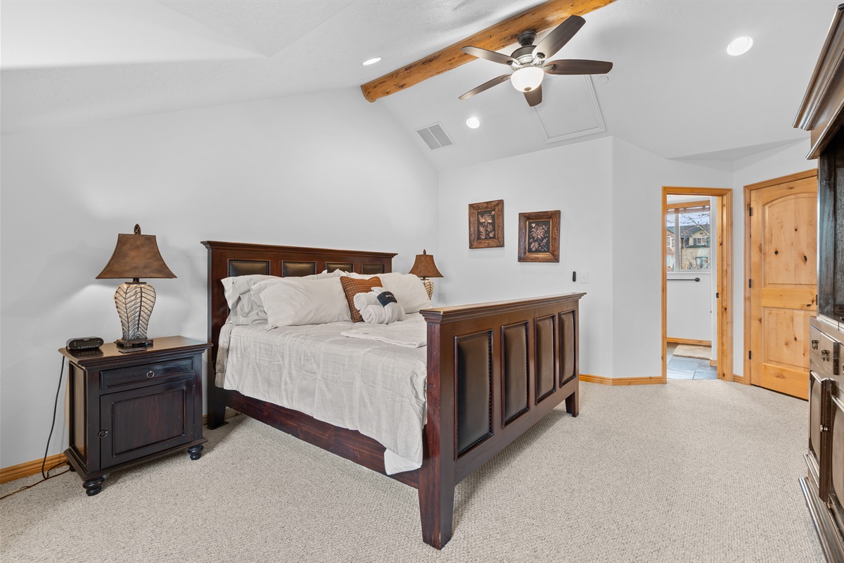 Serene primary bedroom retreat featuring a king bed, warm wood accents, and peaceful mountain-lodge charm.