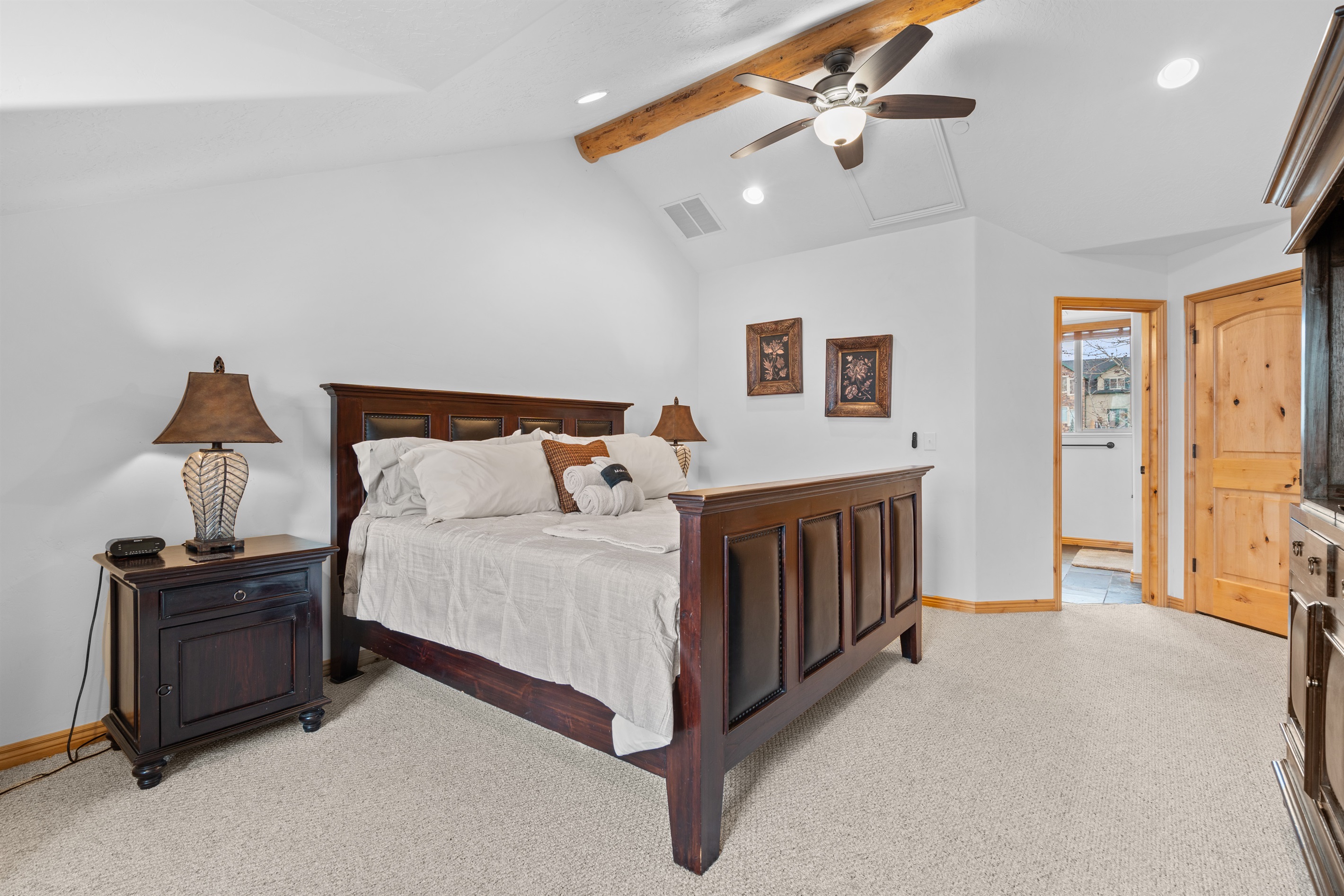 Serene primary bedroom retreat featuring a king bed, warm wood accents, and peaceful mountain-lodge charm.