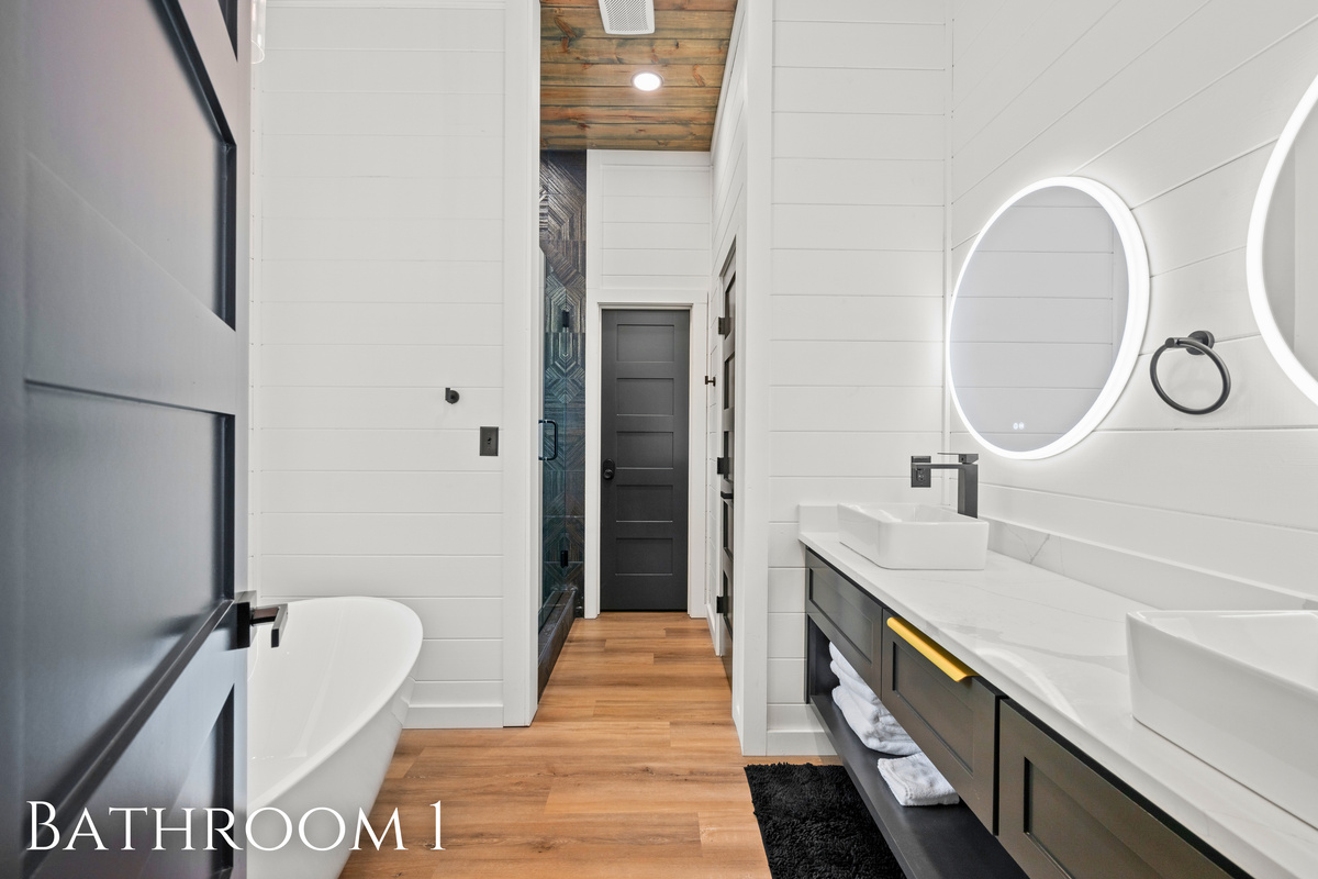 The spacious bathroom features modern fixtures, clean lines, and a calming atmosphere that makes it easy to relax and refresh during your stay.