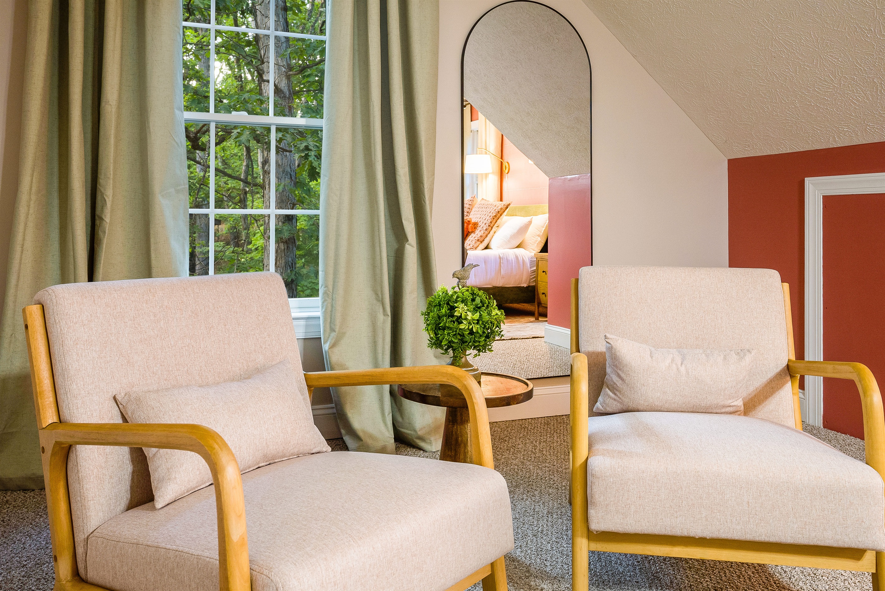 Lounge seating and soft, layered bedding make this space as stylish as it is comfortable.