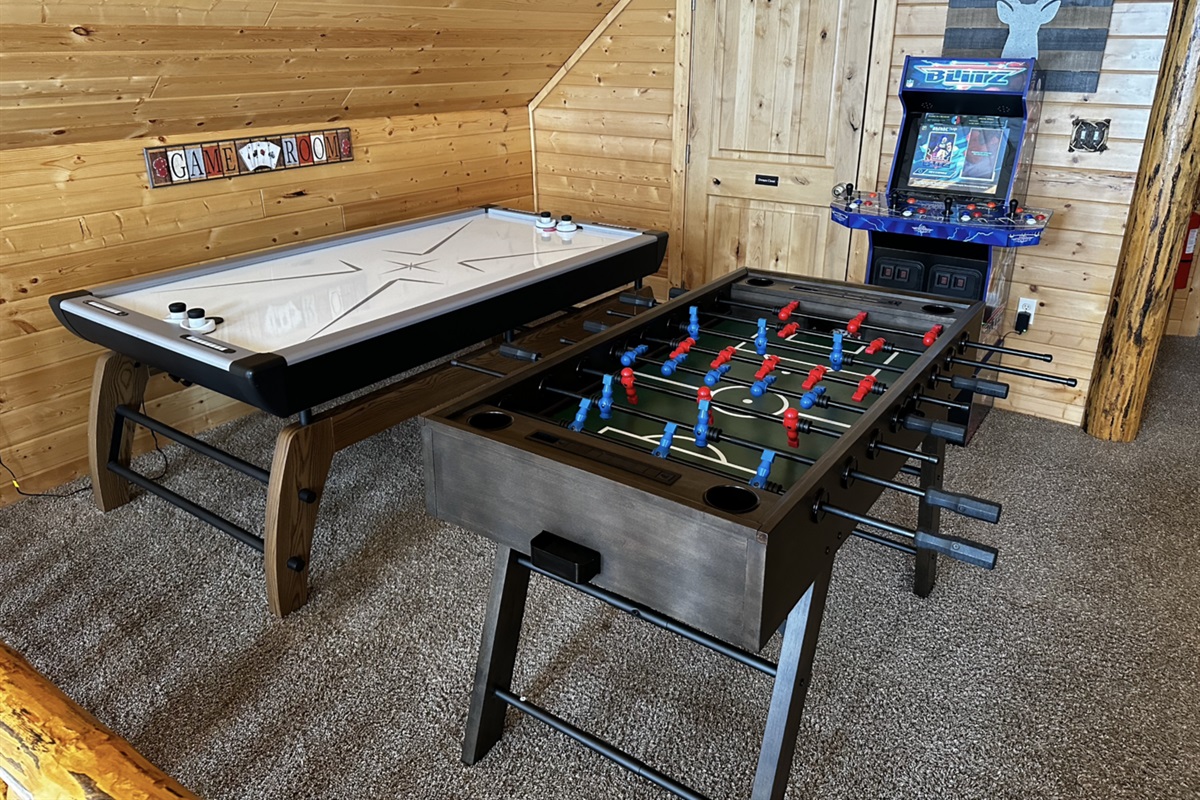 Upstairs game area w/ air hockey, foosball table, and arcade