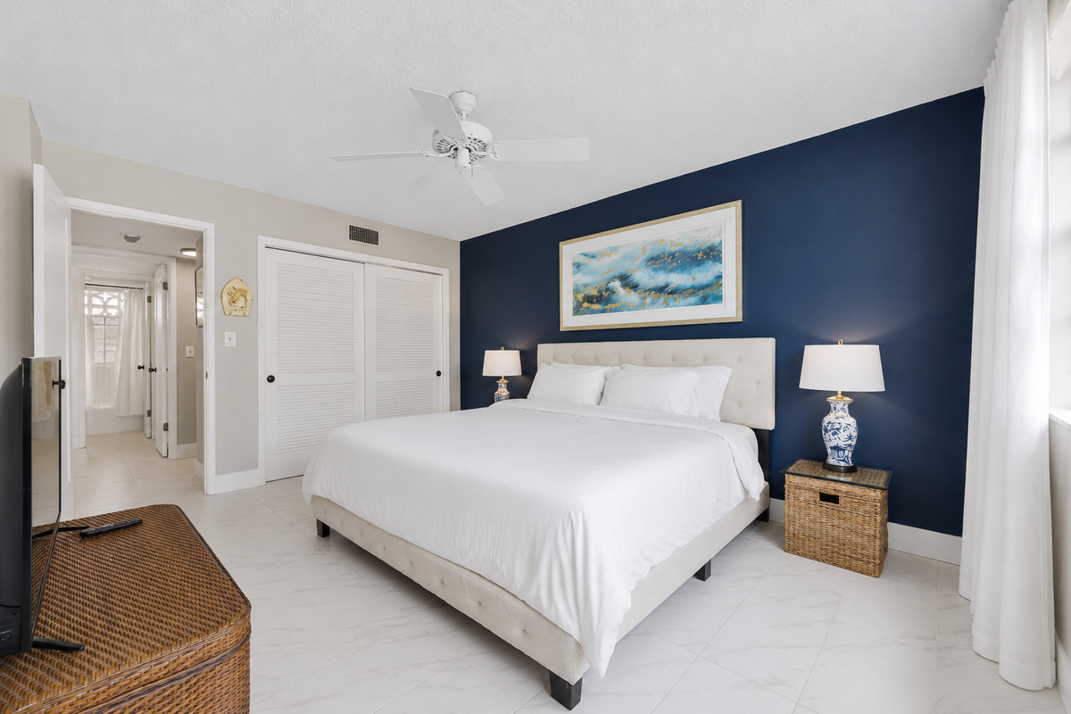 Guest bedroom with a king bed and 45" TV.