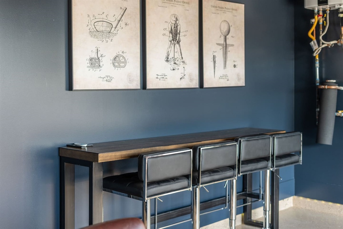 Sleek high-top bar seating with modern stools, perfect for drinks or hanging out between games.