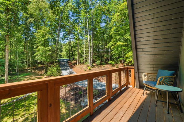This exclusive balcony is off the main bedroom on the second floor. Accessible through french doors and with comfortable wicker chairs with cushions, perfect for enjoying morning coffee overlooking the front yard.