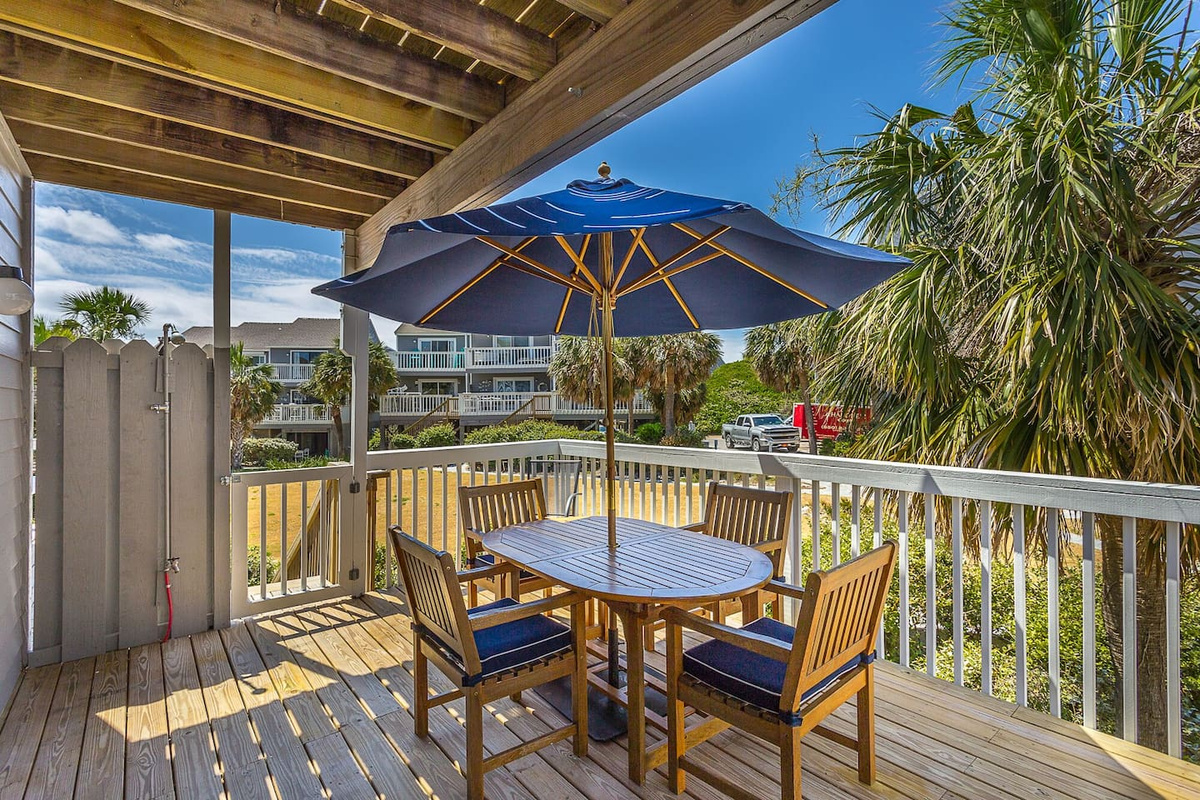 Pull up a chair at the outdoor dining table while the gas grill warms up &mdash; this is where breakfast starts before anyone's hit the beach, and where dinner lingers long after.
