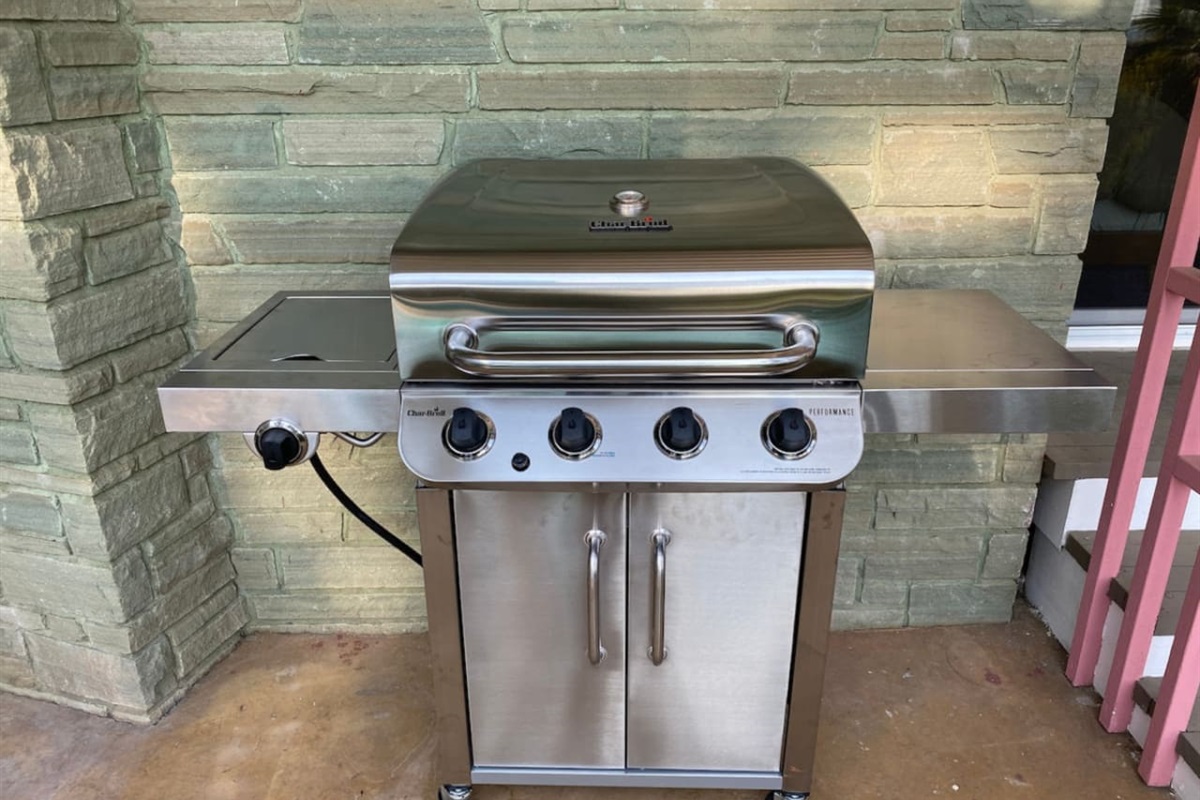 Gas grill located near the pool.