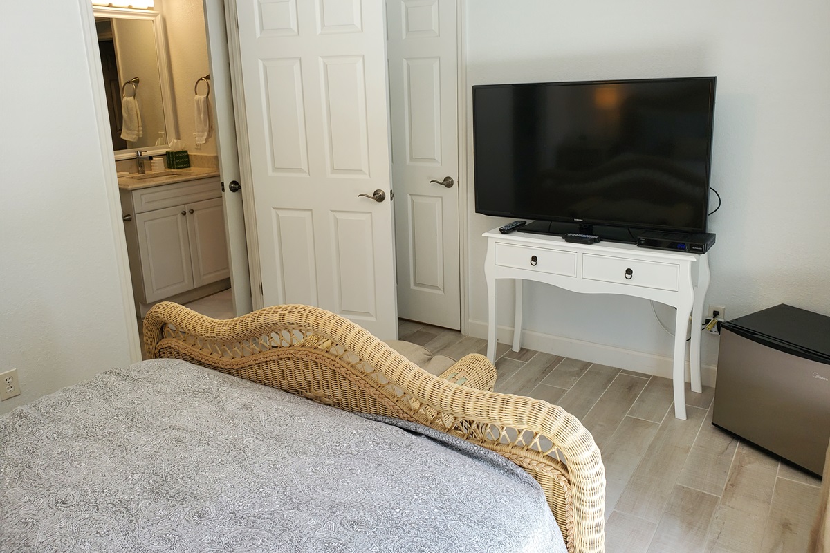 Queen bedroom with smart TV and private full bathroom