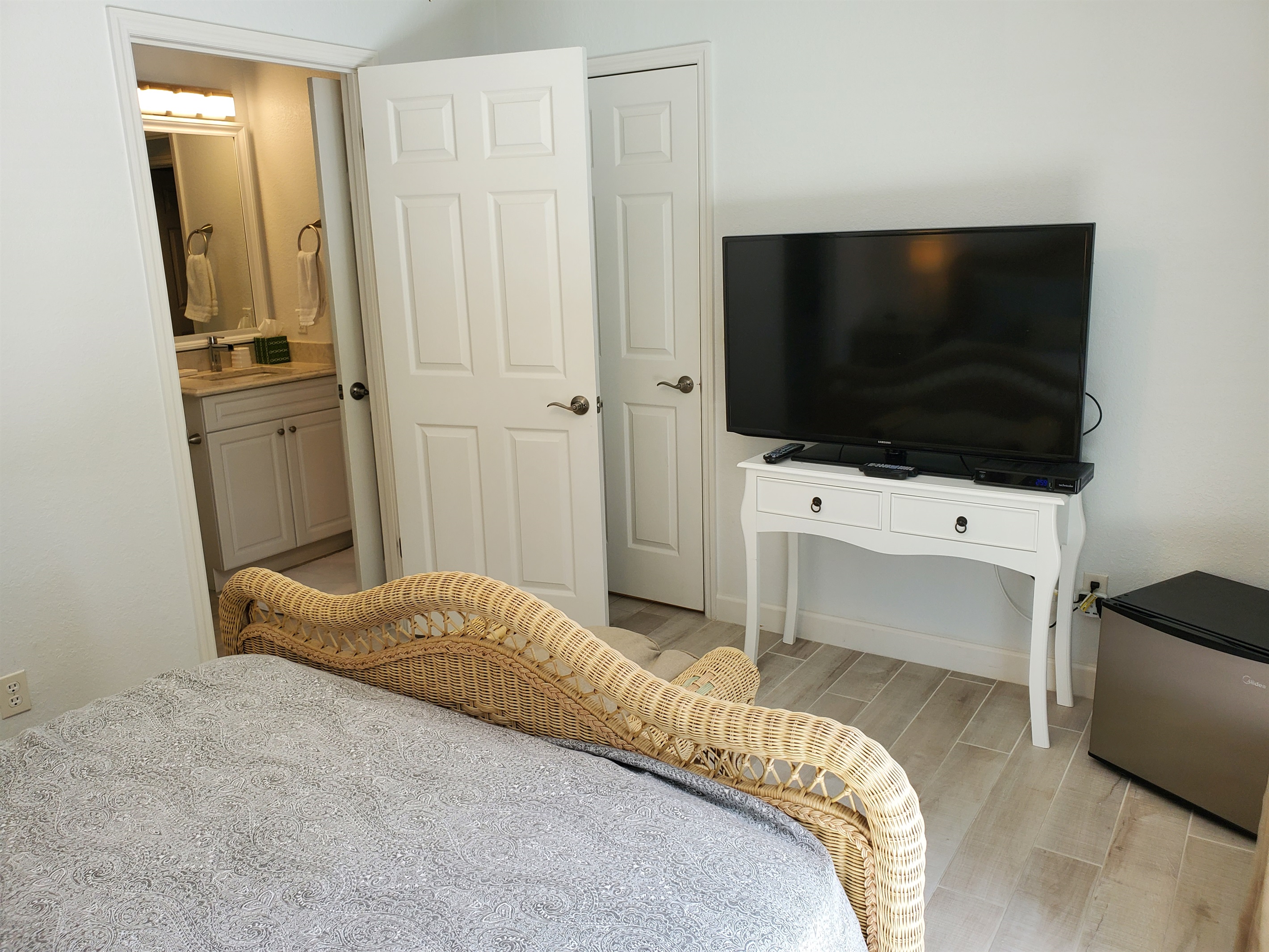 Queen bedroom with smart TV and private full bathroom