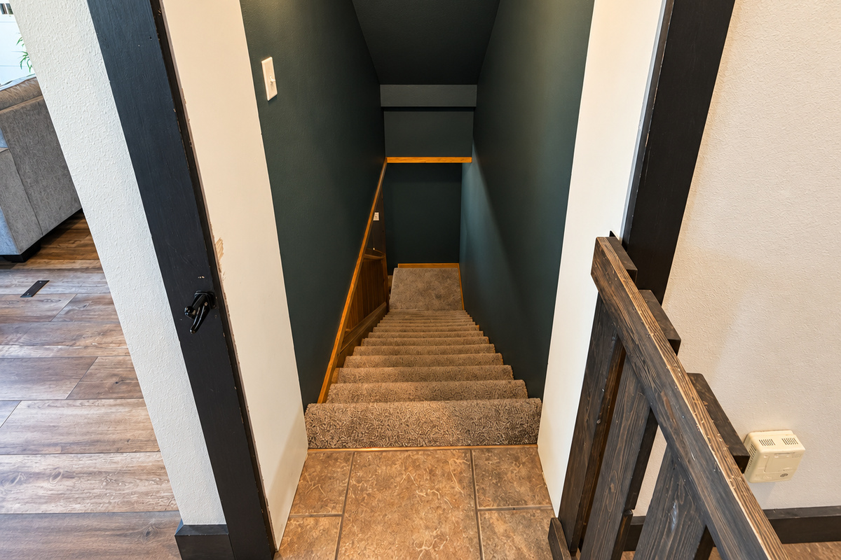 Head downstairs to the basement level, featuring an additional bedroom, full bathroom, comfortable living area, and foosball table—great extra space for families and groups to spread out.