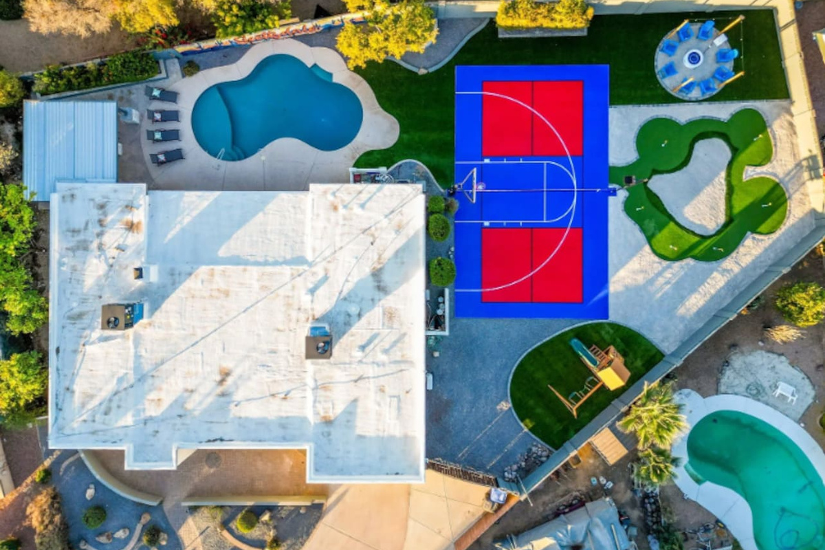 Pool on one side, sport court on the other, putting green in between — this layout was made for a group that wants options.