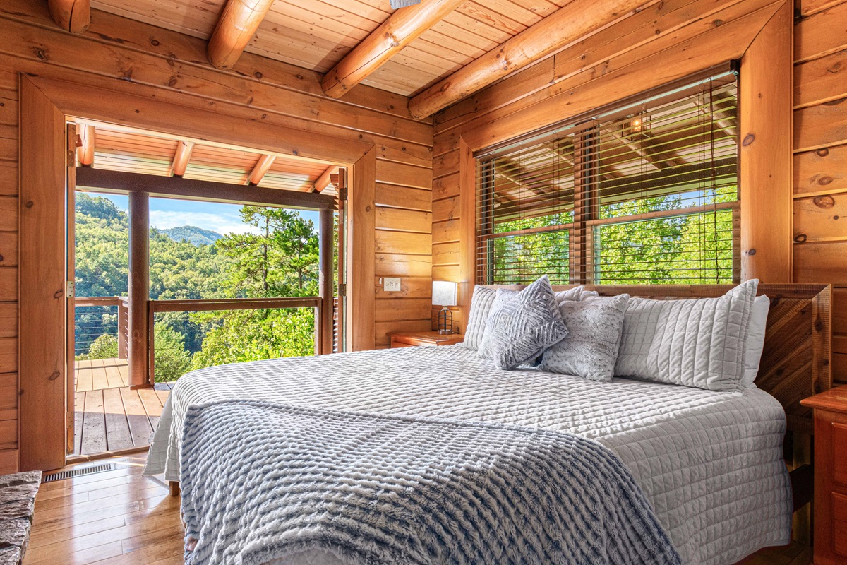 Main Level Master Bedroom: Wake up to stunning mountain views and natural light in this rustic haven!