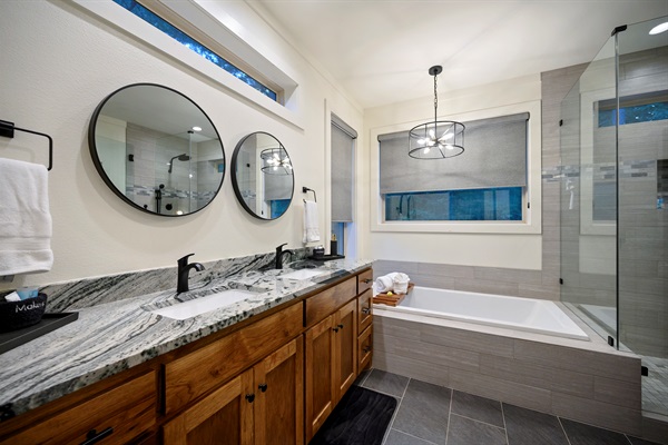 Your private spa retreat — soak in the deep tub, rinse in the glass shower, and unwind surrounded by warm wood and soft light.