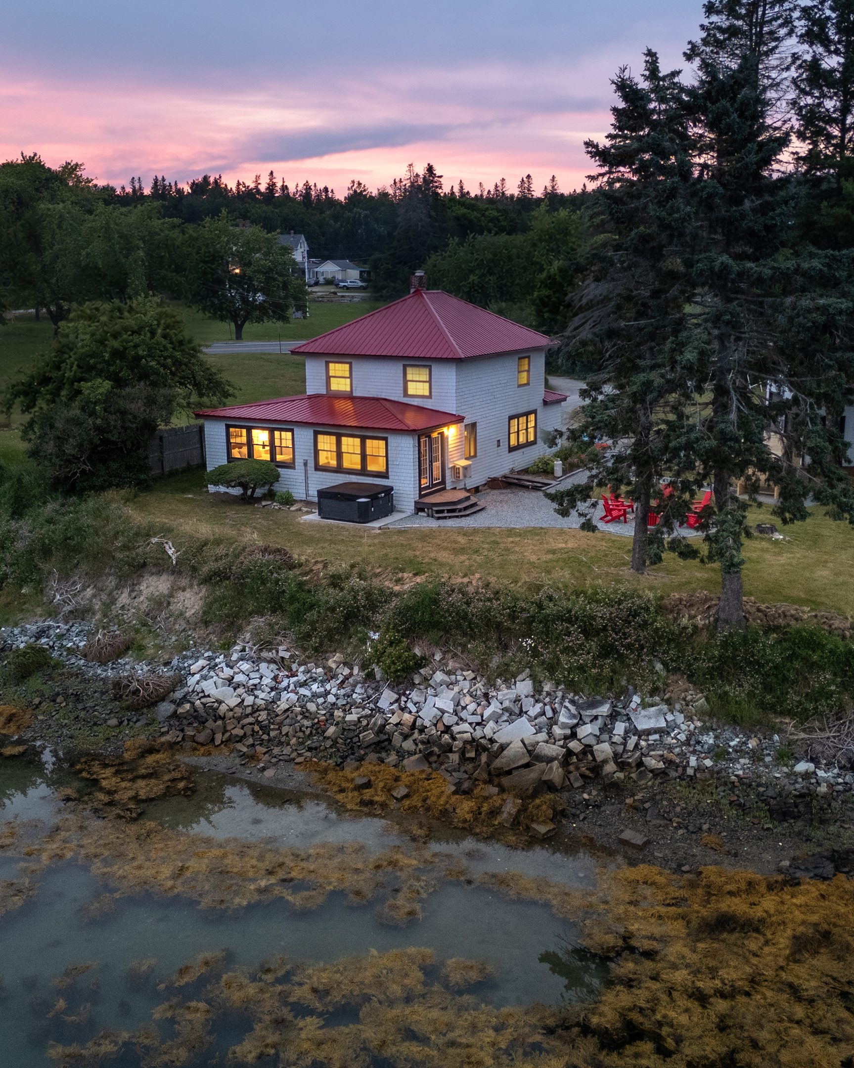 Step onto the back patio and breathe — it runs the full width of the house so everyone gets a water view at the exact same time.
