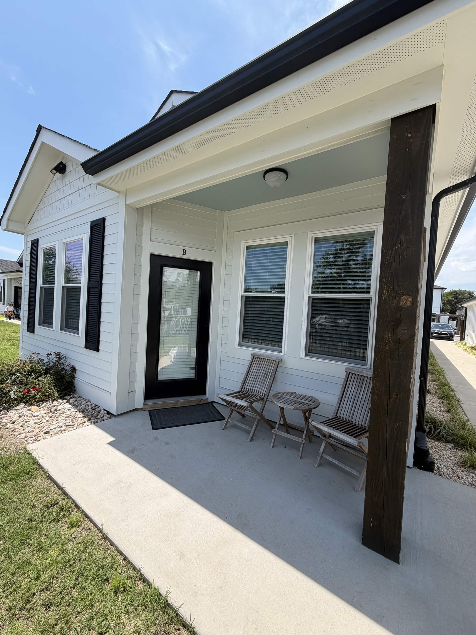Covered front porch with comfortable seating—perfect for morning coffee or evening relaxation.
