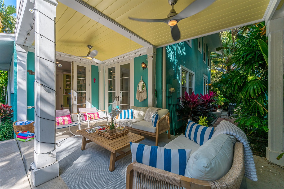Step into your private tropical oasis featuring a heated pool, sun loungers, an outdoor shower, and a romantic string-lit cabana. Enjoy relaxing or entertaining under the covered patio with comfortable seating and dining, and magnificent pool views.
