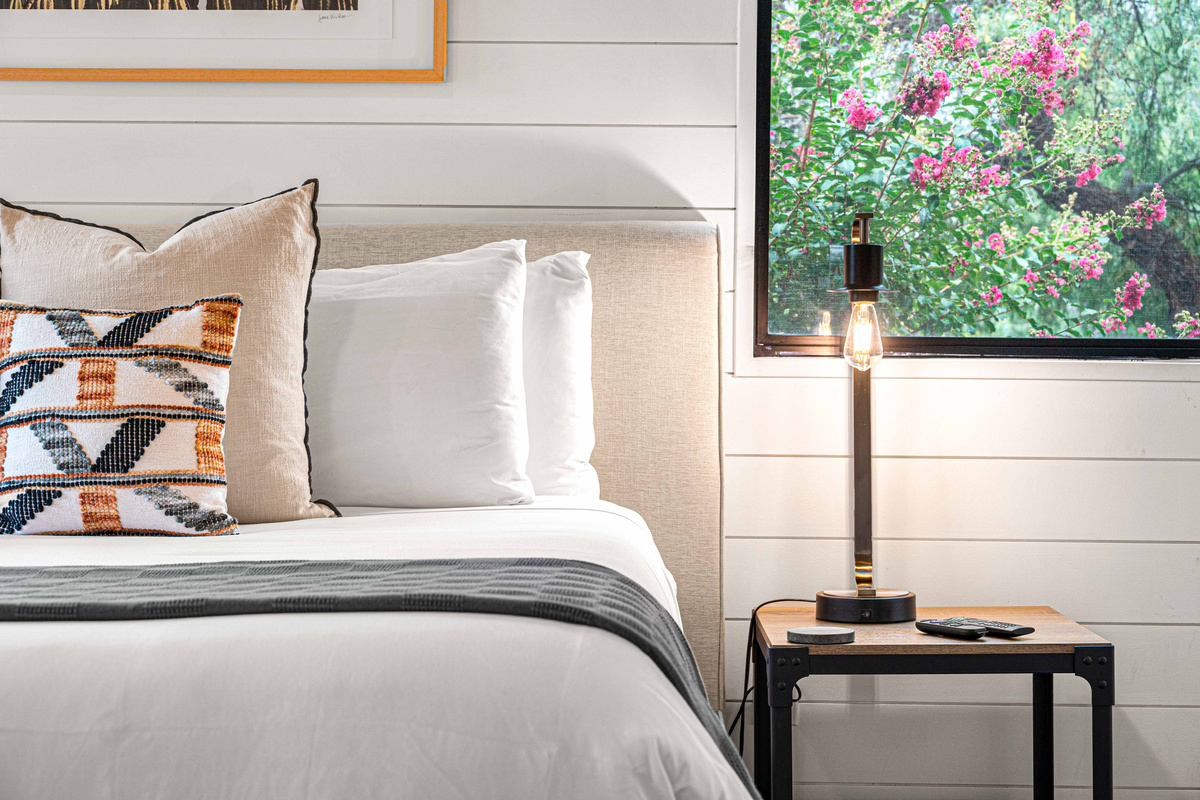 {Bedroom 2} Relax in a bright king bedroom with TV, thoughtful furnishings and easy access to its private ensuite bath.