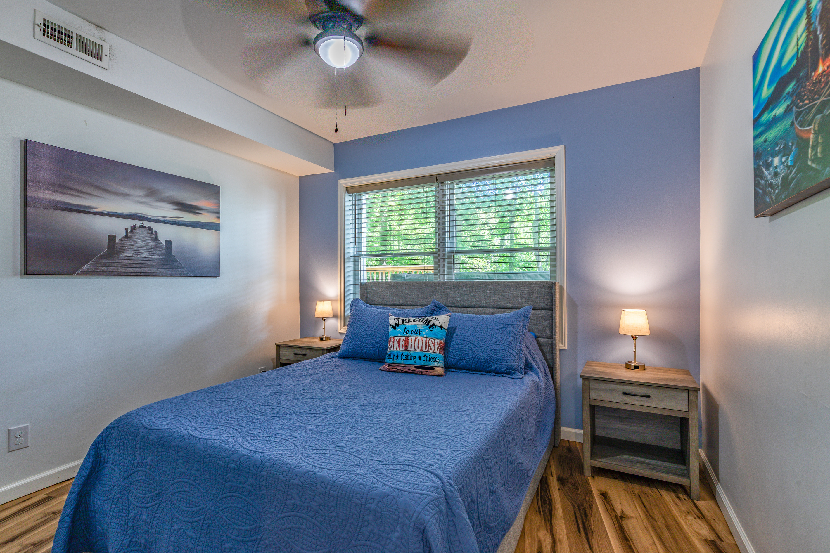 Downstairs Bedroom 4 offers a queen bed, bedside lighting, and a comfortable retreat from the gathering areas.