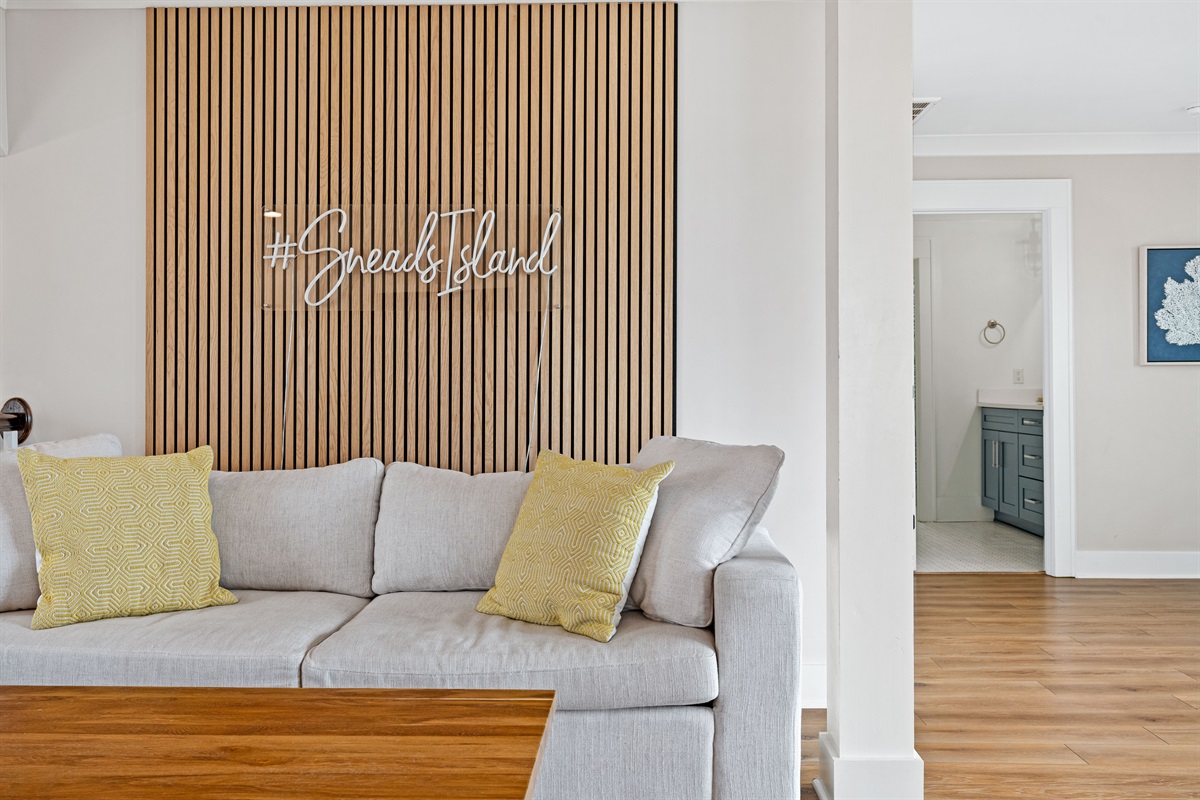 Stylish upstairs lounge area with cozy seating and custom Sneads Island d&eacute;cor accents