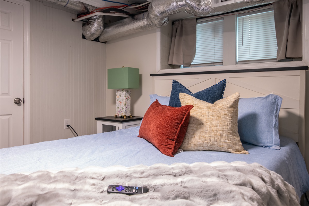 A warm and inviting bedroom accented with modern lighting and plush pillows