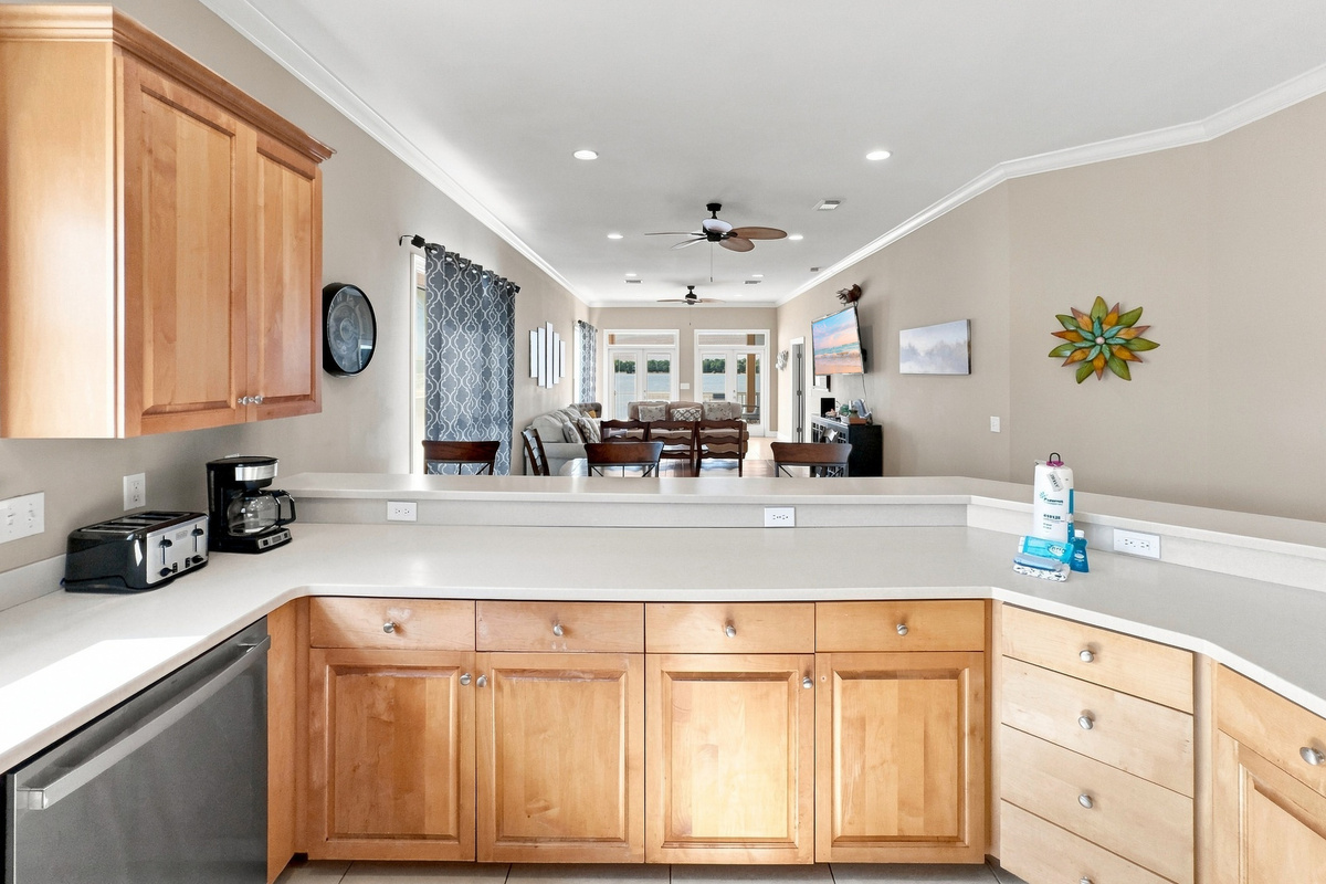 Open kitchen with breakfast bar flowing into the living space