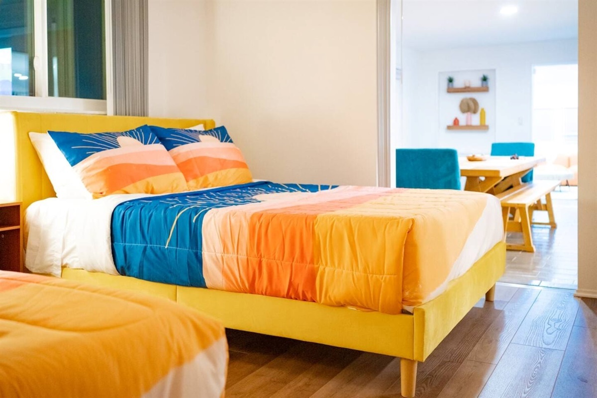 Bedroom with 2 queen size beds. Glass door opens to the dining room and overlooks the pool.