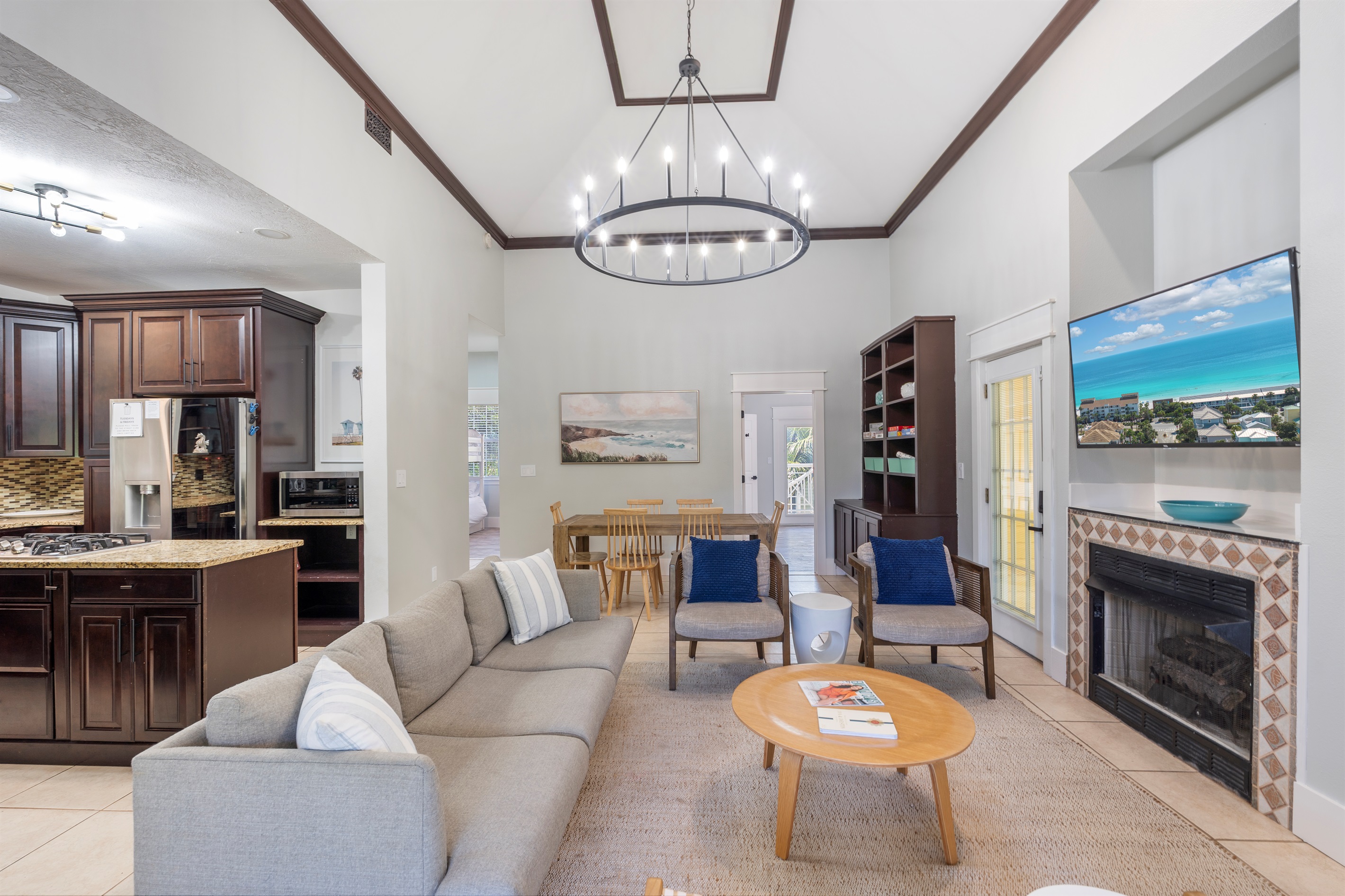 The living room is open to the kitchen and dining area and is surrounded by a wrap around enclosed porch