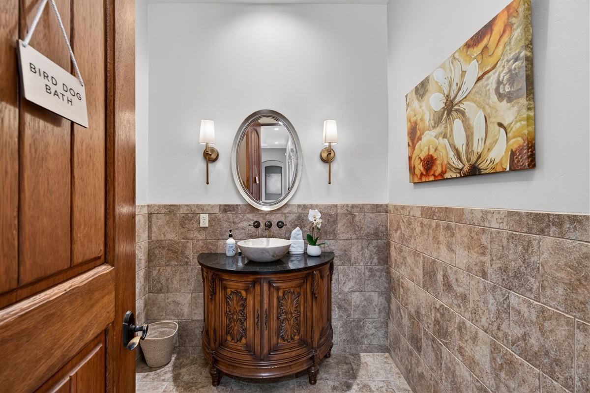 Additional first-floor full bathroom with vanity and fresh towels for convenient guest access
