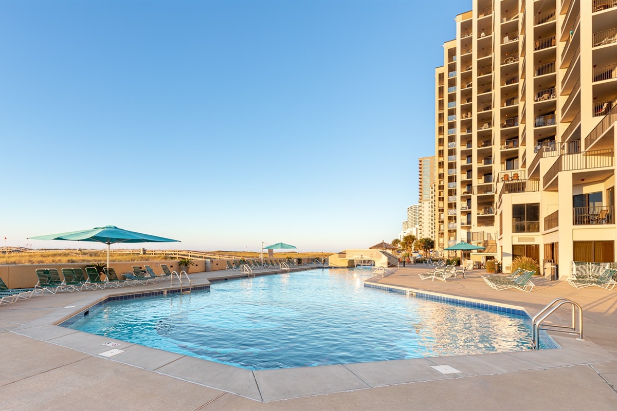 Blue water that seems to go on forever!! TONS of room at the outdoor pool to enjoy!