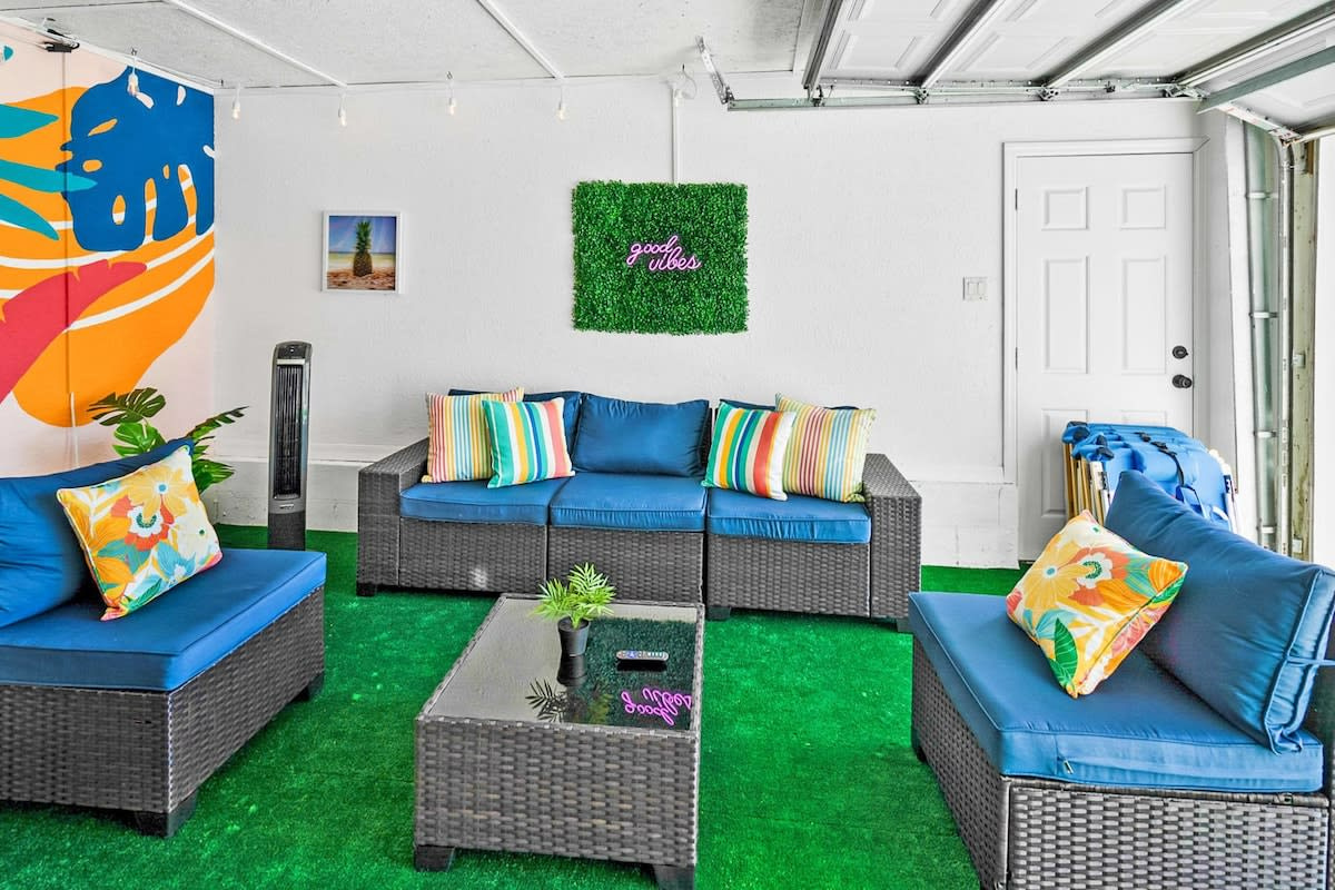Sofas arranged for conversation, cushions in every colour, and a smart TV on the wall for the big match. The lounge stays cool and shaded even when the deck outside is properly baking in the afternoon.