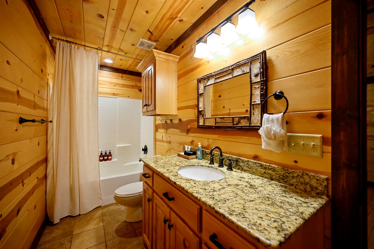 Fresh + bright bathroom with warm wood and granite touches.