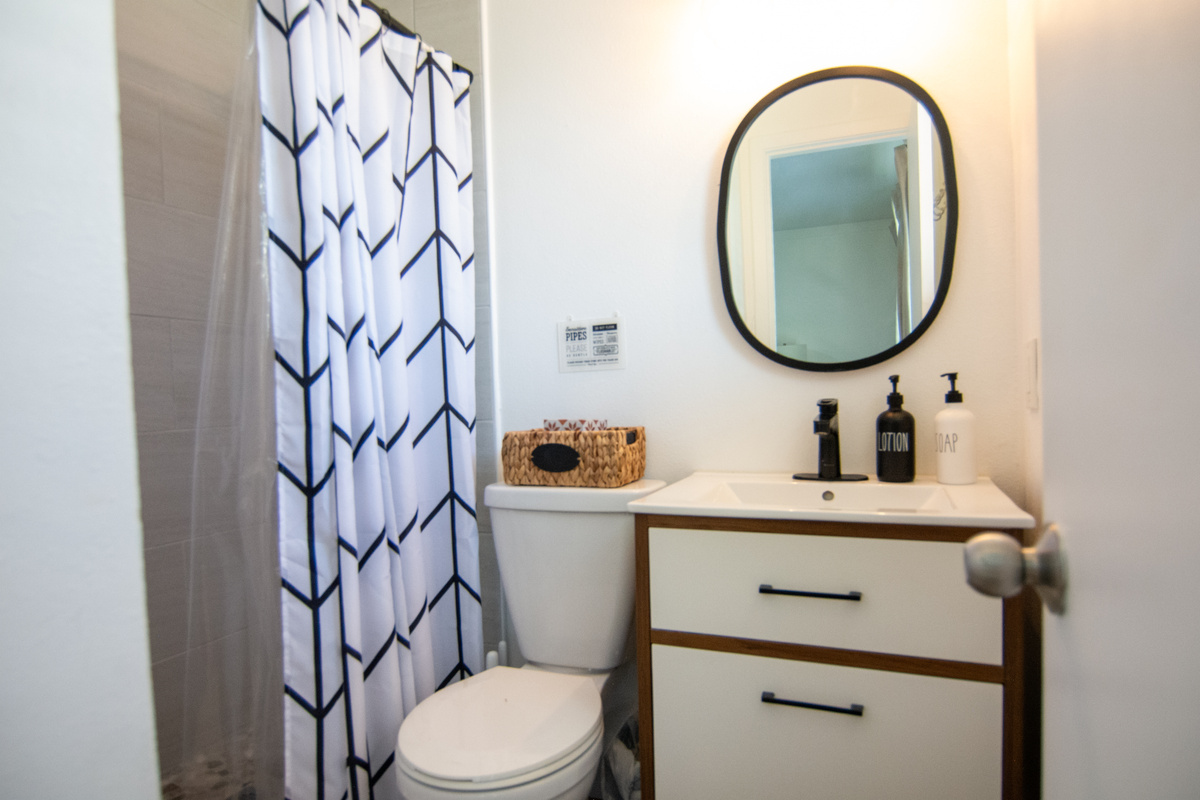 1BR – Modern bathroom with walk-in shower, modern vanity and hotel-style toiletries