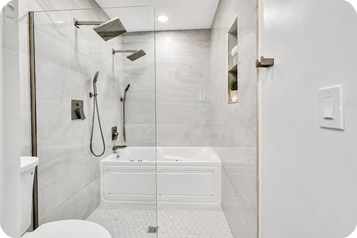 Spa-style full bathroom with a jetted tub, rainfall shower and handheld showerhead.