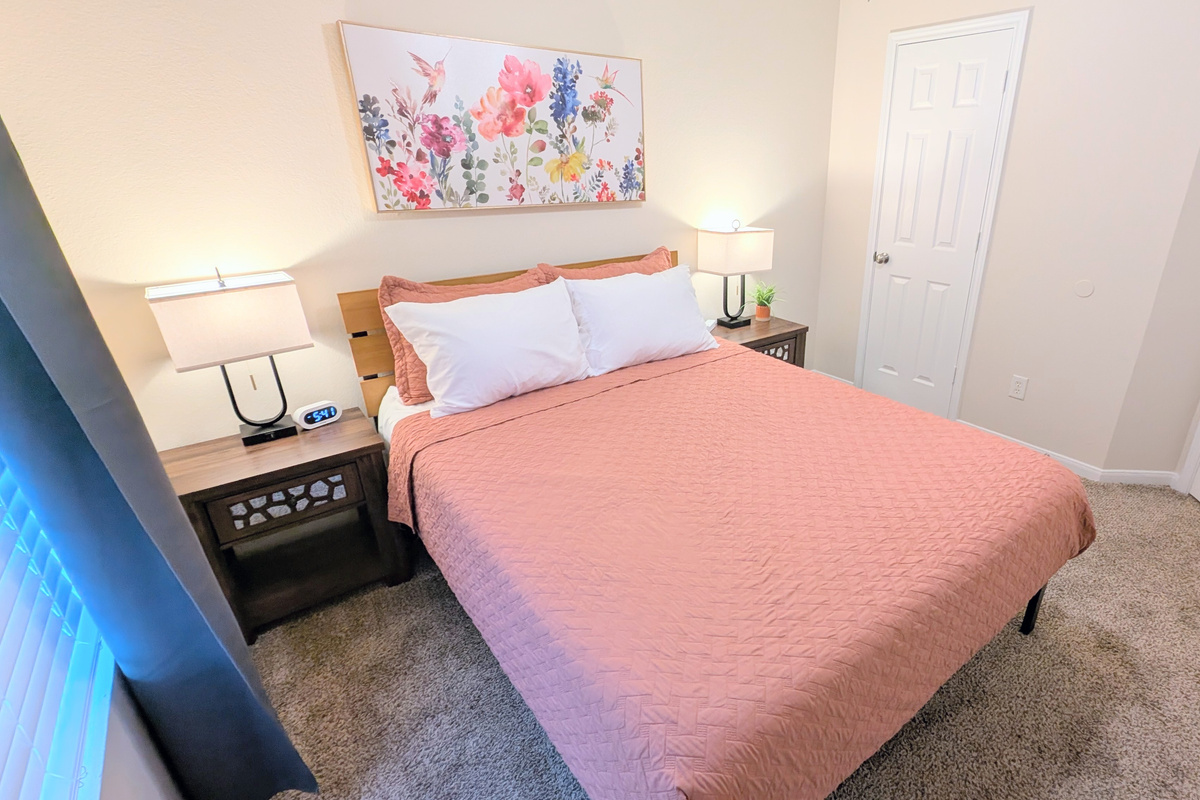 The queen bedroom has plenty of space in the closet for storage as well as hooks on the door. 