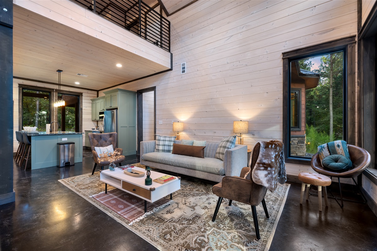 Additional seating area in the living room featuring a second sofa set placed just behind the main lounge space, offering extra comfort and flexibility for larger groups while maintaining an open, connected layout for socializing and relaxation