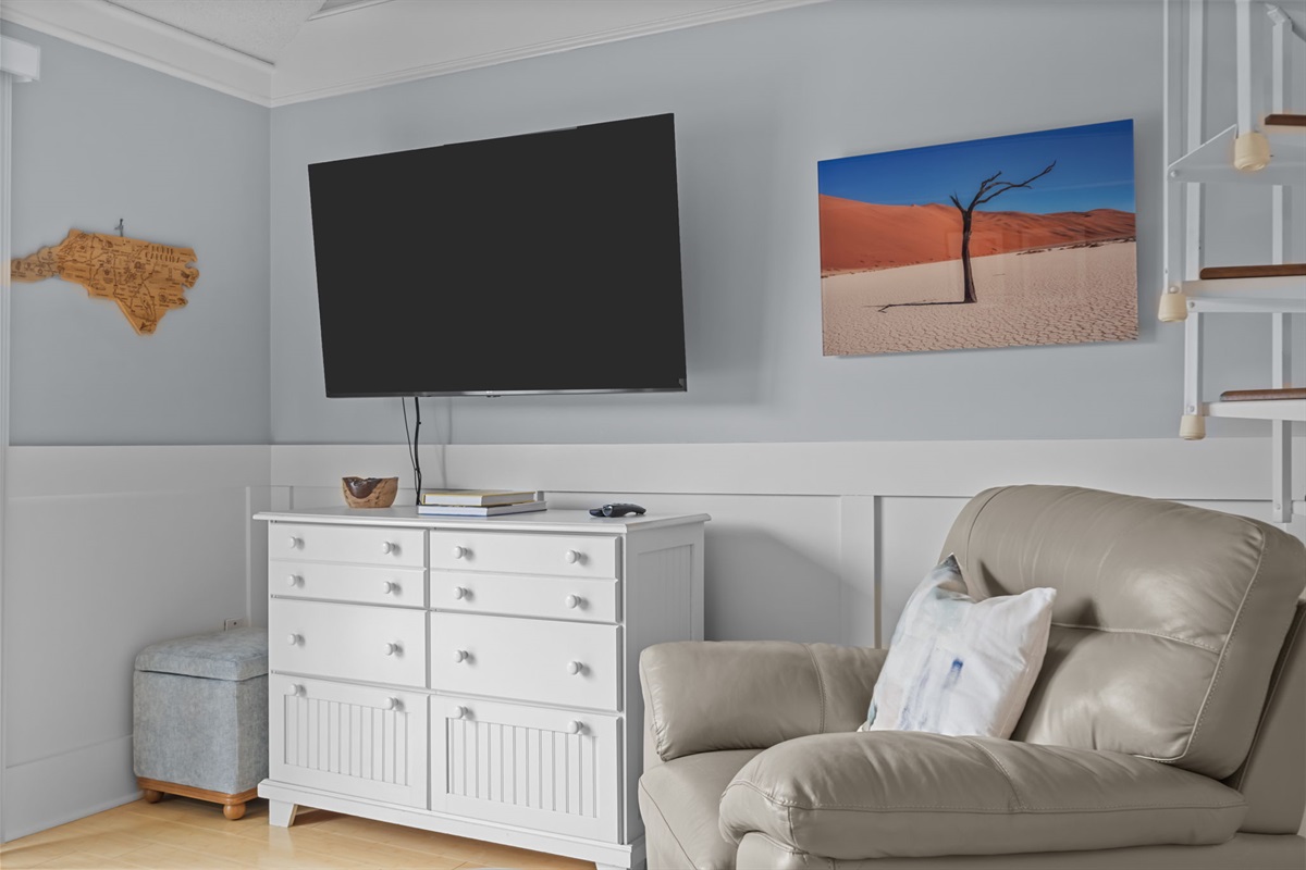 Relax in the airy living room with plush seating and a large TV&mdash;perfect for movie nights after a day at the beach