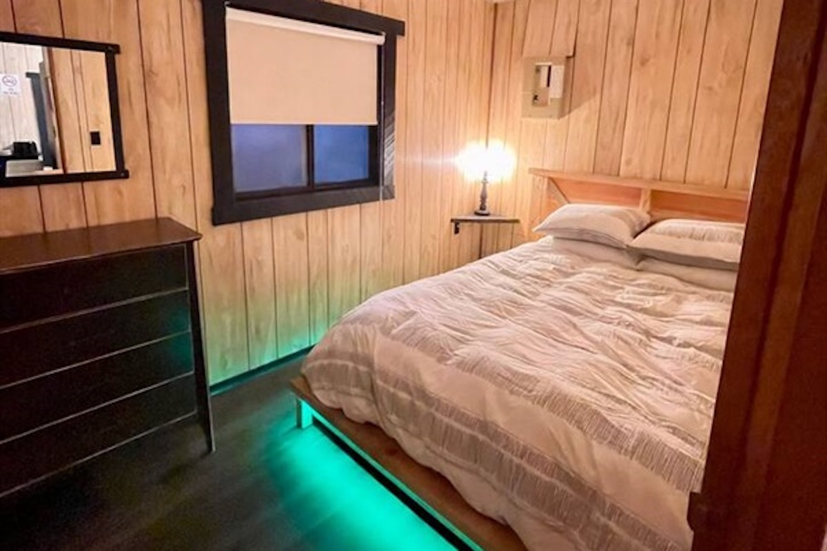 Cozy bedroom with bedside lighting and dresser