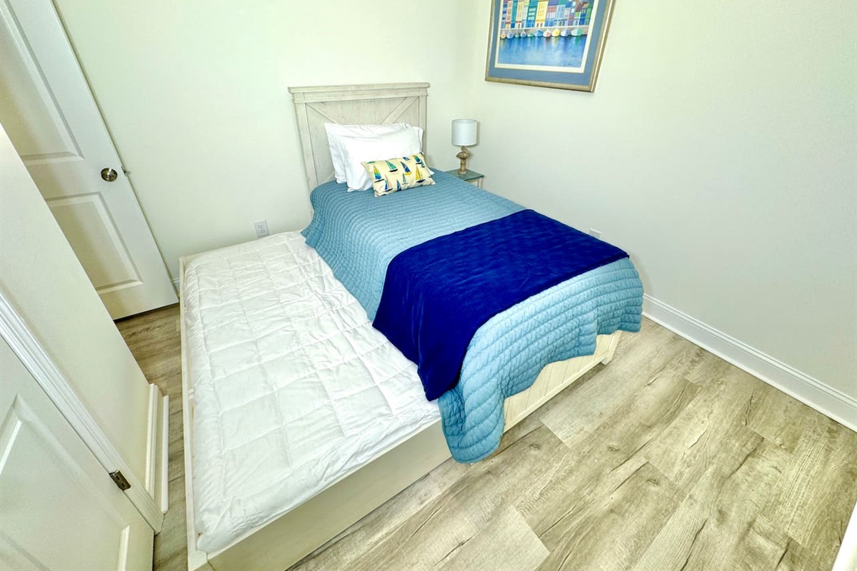 Twin trundle bed with blackout curtains. Linens for bottom twin trundle bed in closet. 