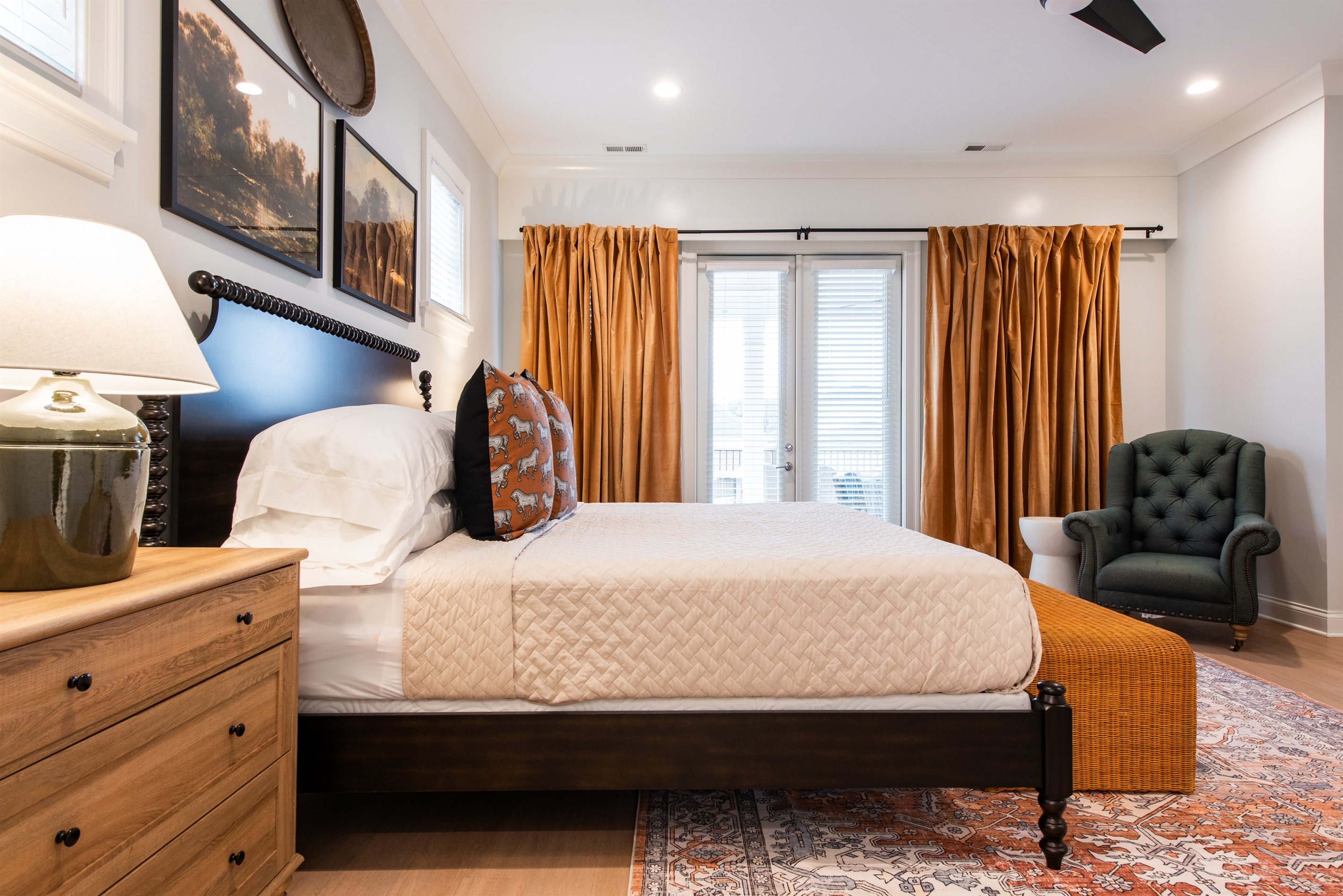 This spacious bedroom features a luxurious **king-sized bed** draped in fine linens, ensuring a comfortable night's sleep.
