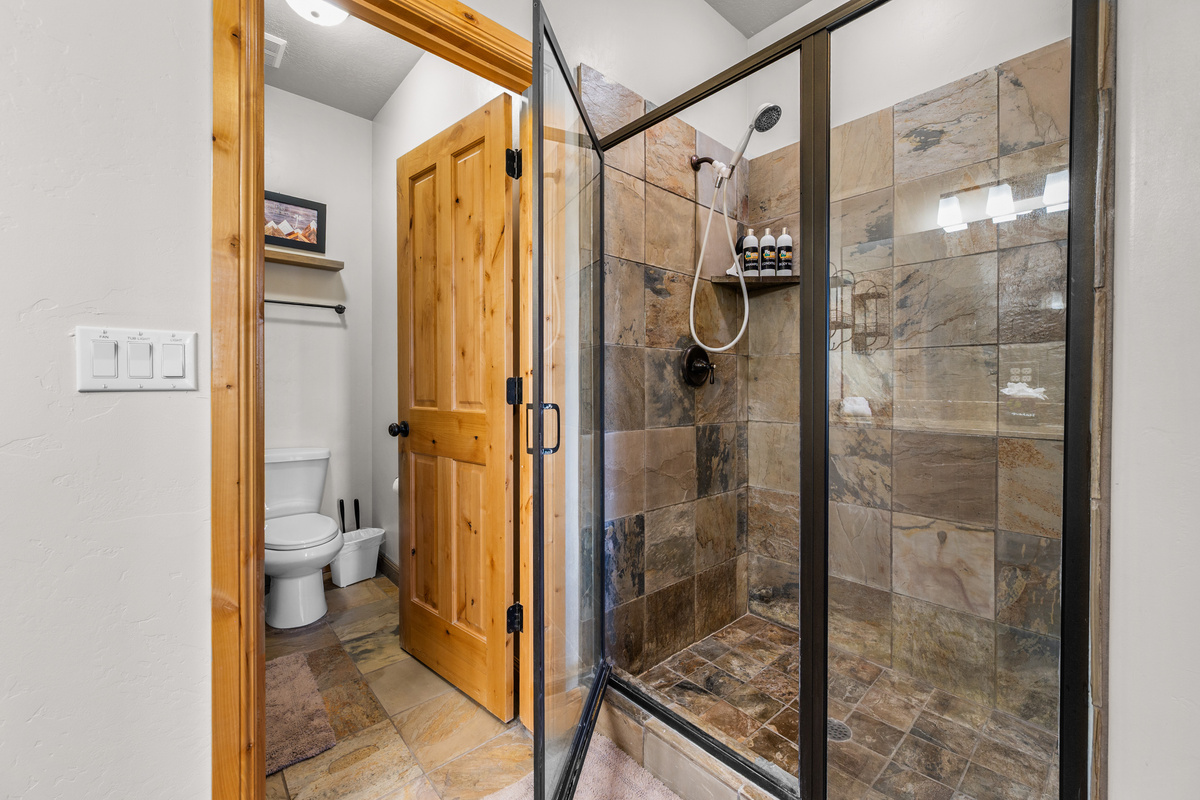 Spacious walk-in shower with beautiful tile finishes.