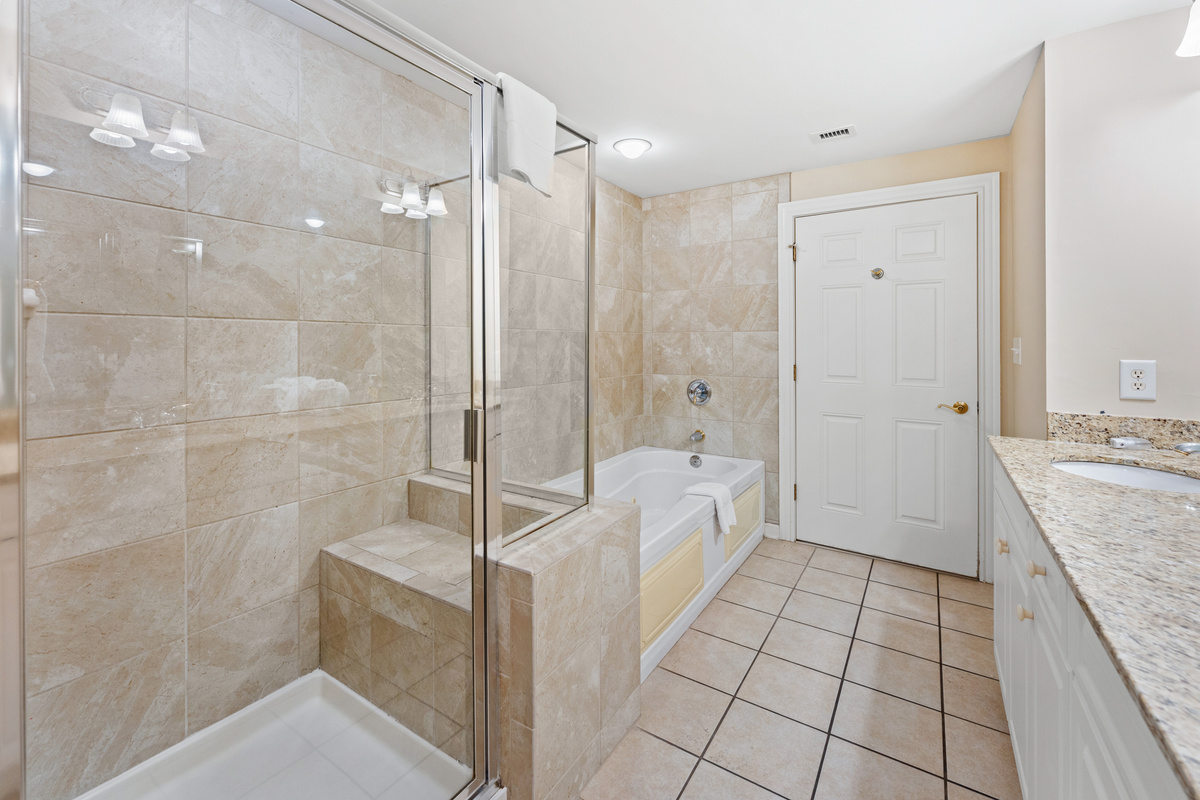 Main Bathroom with double sinks, stand along shower and jetted tub.