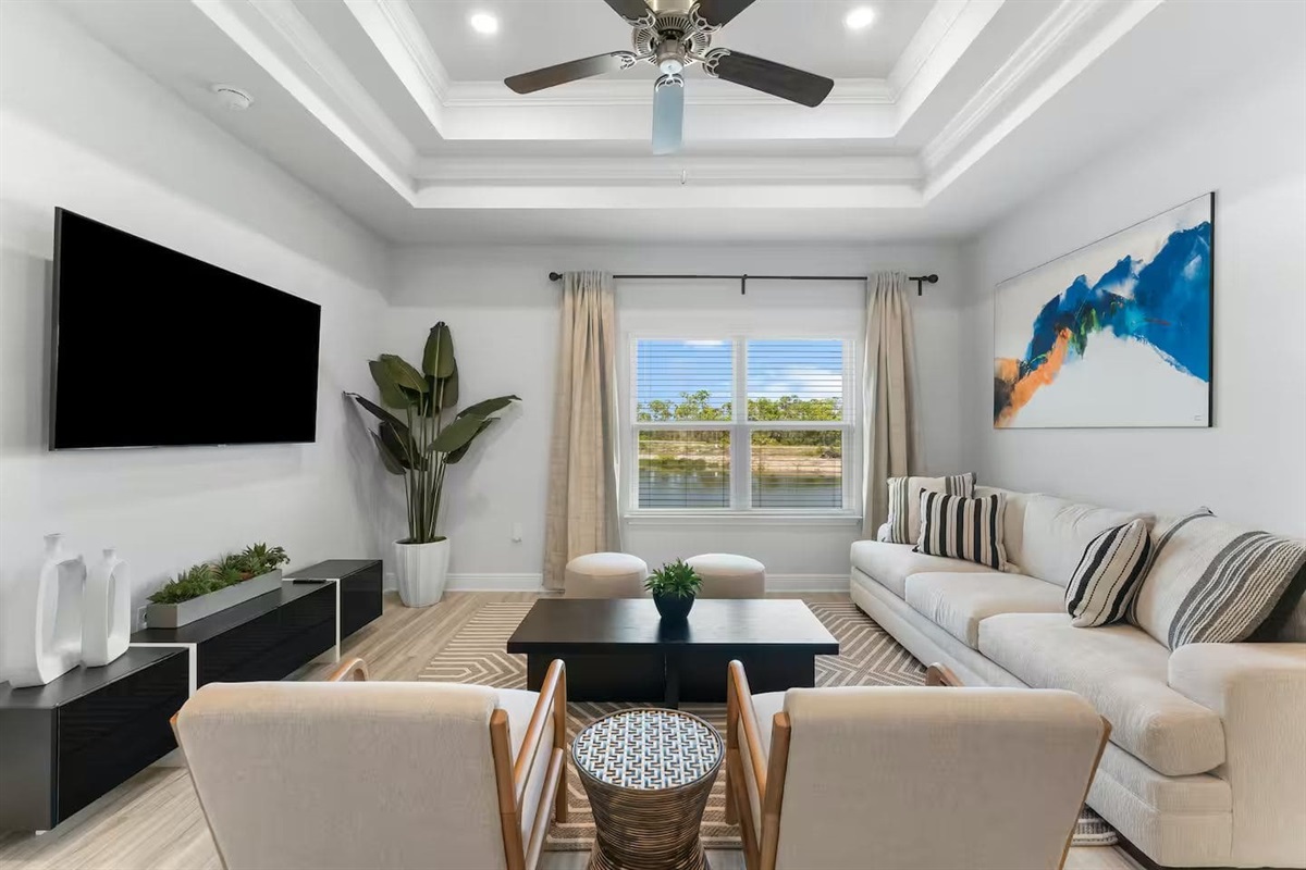 Spacious open-layout living area, Smart TV, and Ceiling fan perfect for relaxing nights or entertaining guests.