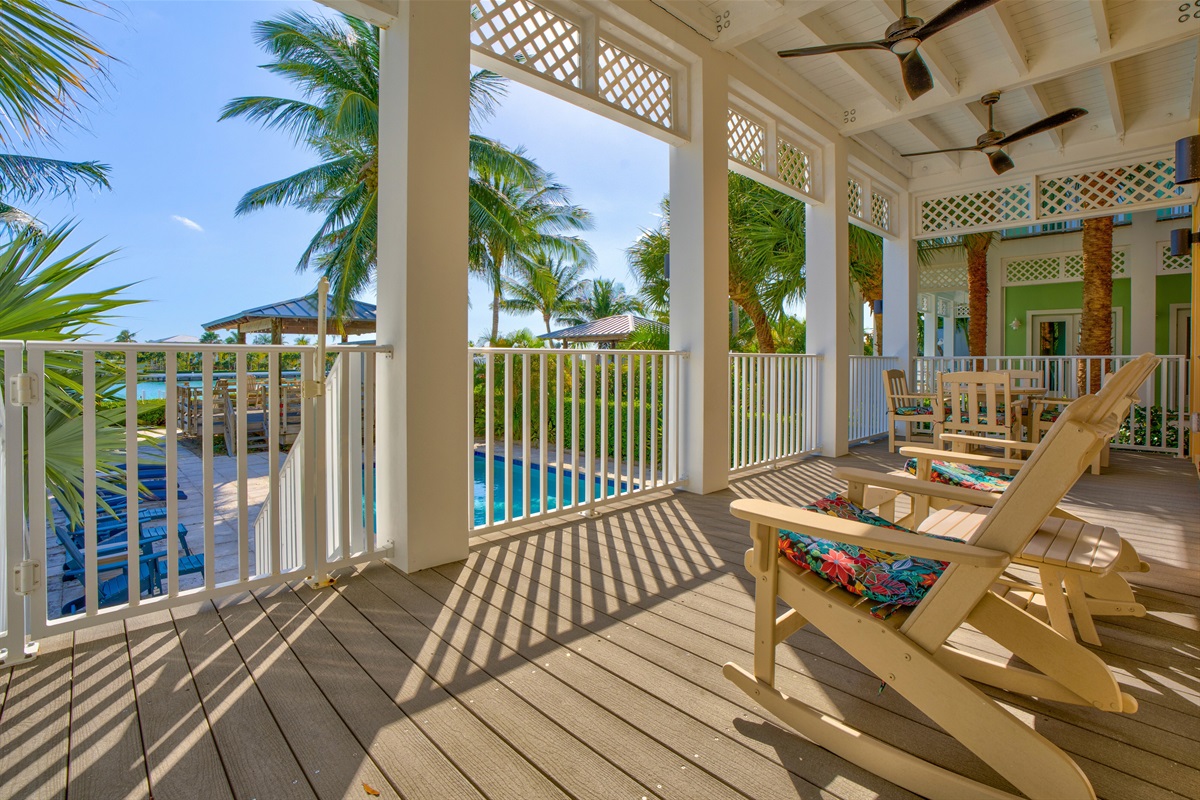 Relax on the porch while overlooking the pool and open water.