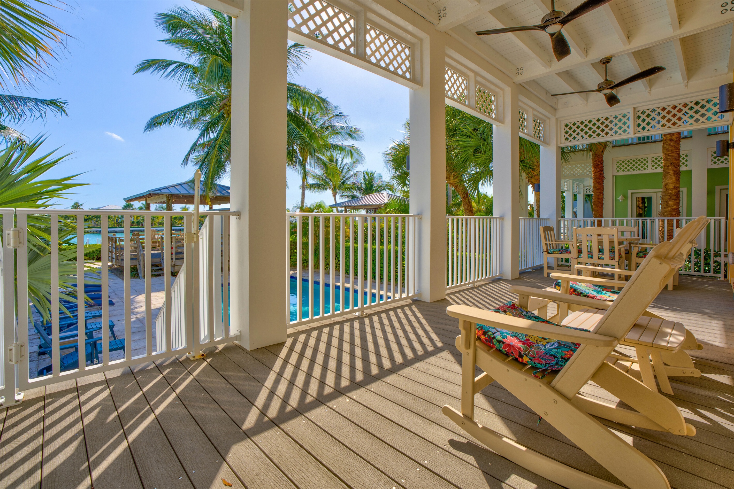 Relax on the porch while overlooking the pool and open water.