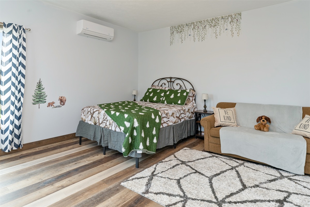 Inviting Queen bedroom with queen fold out sofa woodland-themed décor, and plenty of space to unwind. Bedroom #4