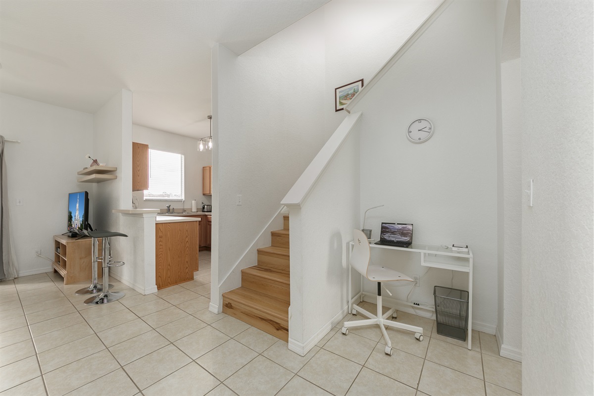 By the stairs that lead to the upper floor, is your working space to stay connected
