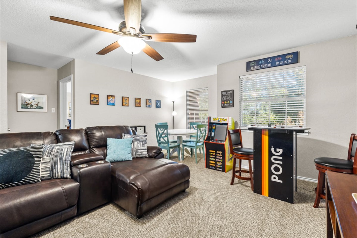 Private cinema and game room featuring a large-screen HD display and classic Pac-Man arcade, perfect for relaxing and having fun with the group.