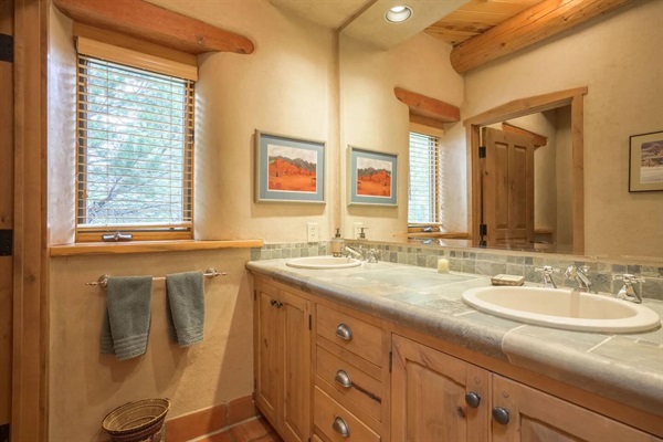 Bathroom three has a double vanity and walk-in shower.