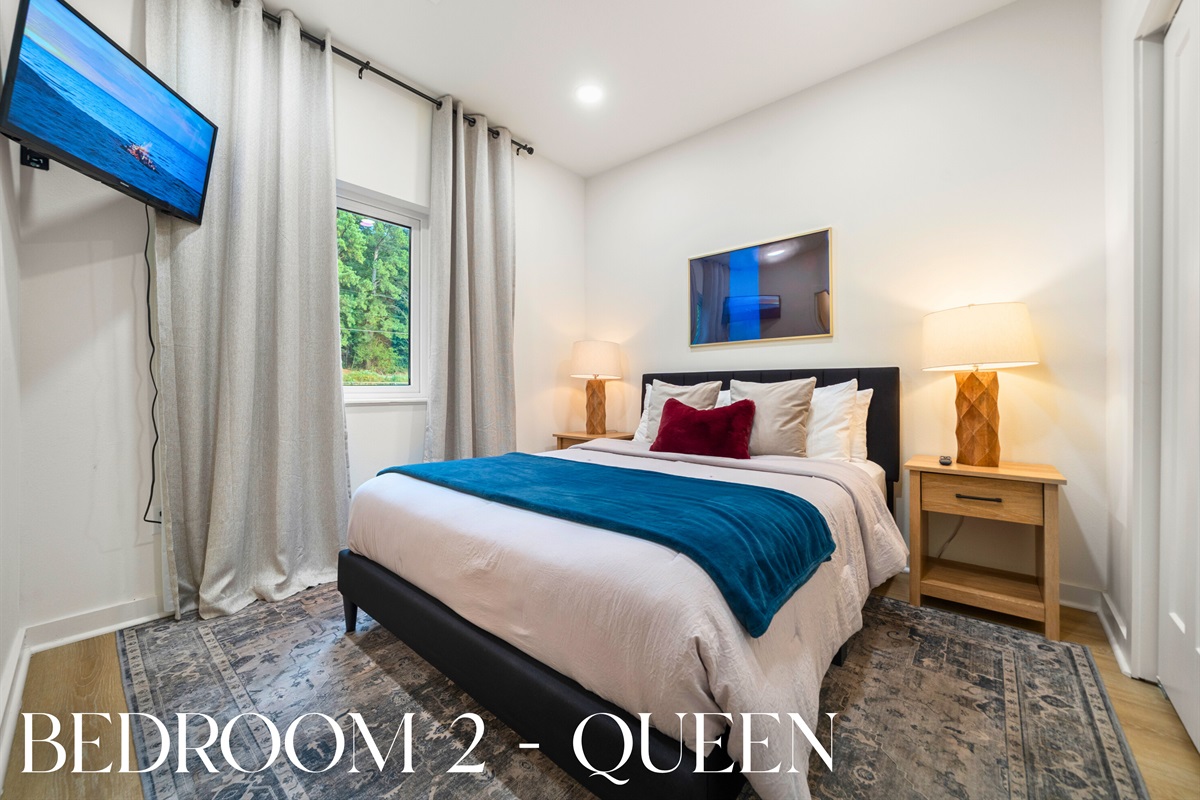 Guest bedroom with calm tones and comfortable bedding.