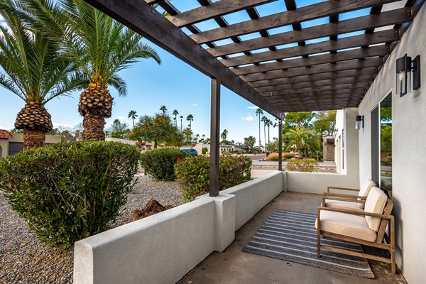 Sit on the front veranda under the pergola as dusk settles in on the desert.